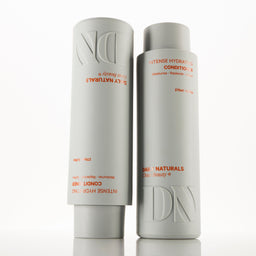 Two bottles of Daily Naturals hair care products on a white background