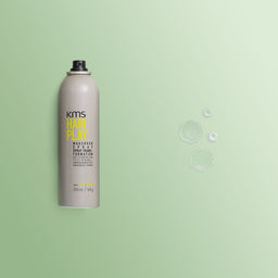 KMS Hair Play spray can on a green background
