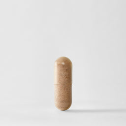 Beige pill-shaped container on a light gray background