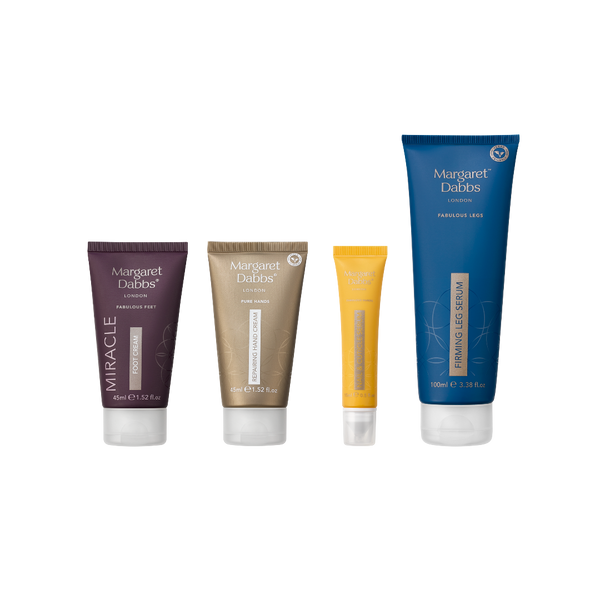 Four Margaret DaBbos cosmetic tubes arranged in a row on a plain white background: a dark purple Miracle Hair Growth tube, a metallic gold Miracle Shine + Volume tube, a small yellow tube, and a tall blue Fabulous BS Serum tube.