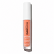 HydroReptide Perfecting Gloss lip enhancing treatment in a clear tube showing a peachy orange liquid, topped with a white cap, on a white background.