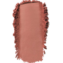 Nude-colored makeup swatch with textured edges on a white background