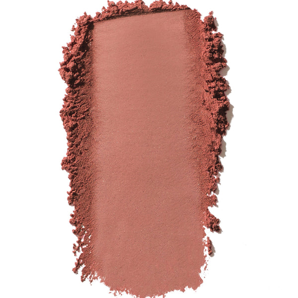 Nude-colored makeup swatch with textured edges on a white background