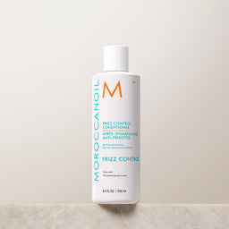 Moroccanoil frizz control conditioner bottle on a light background