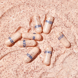 a mixture of capsules on a sandy surface