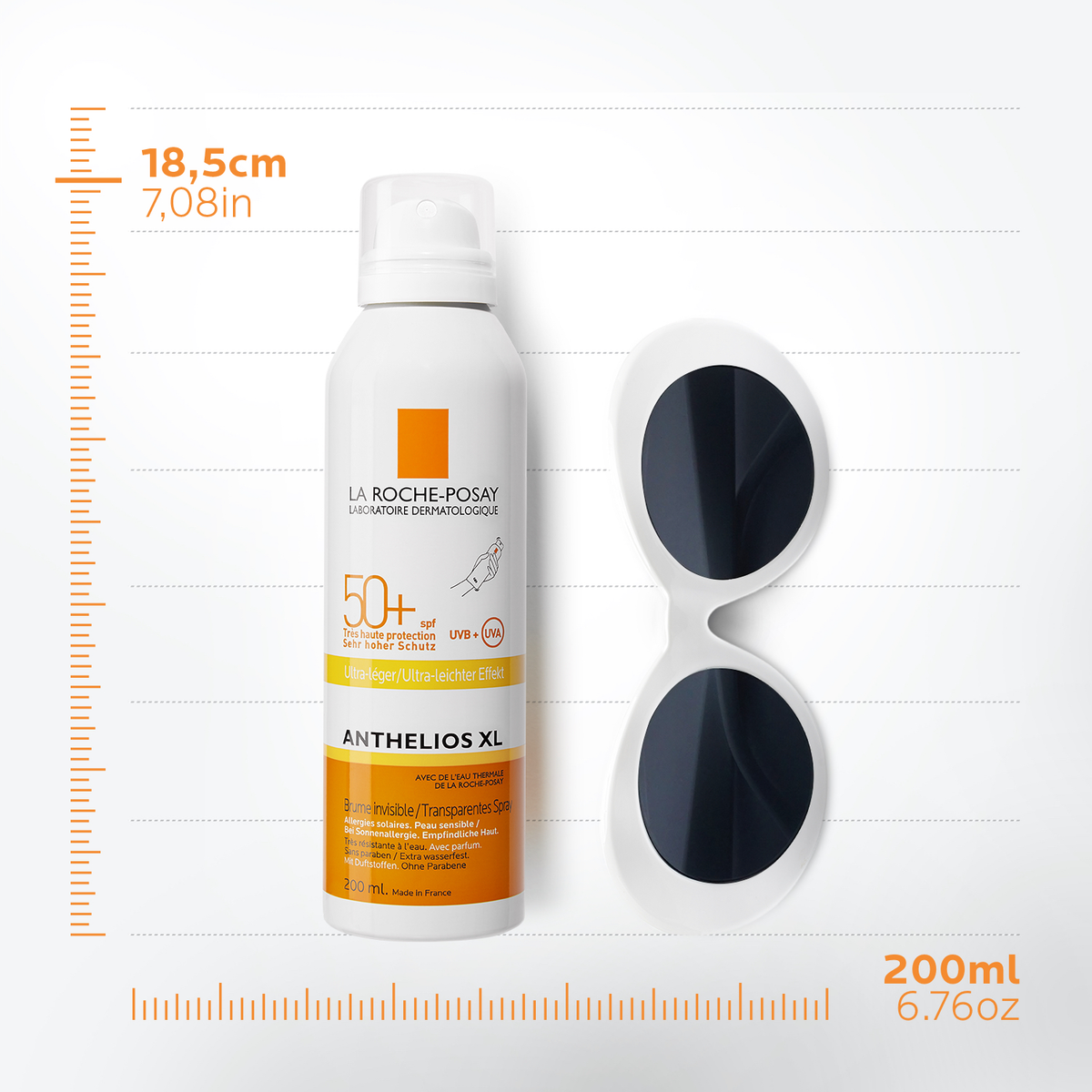 A bottle of the mist next to a set of sun glasses