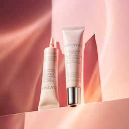 Two skincare products on a pink background