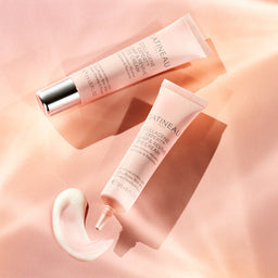 Two tubes of Gatineau eye cream on a pink background