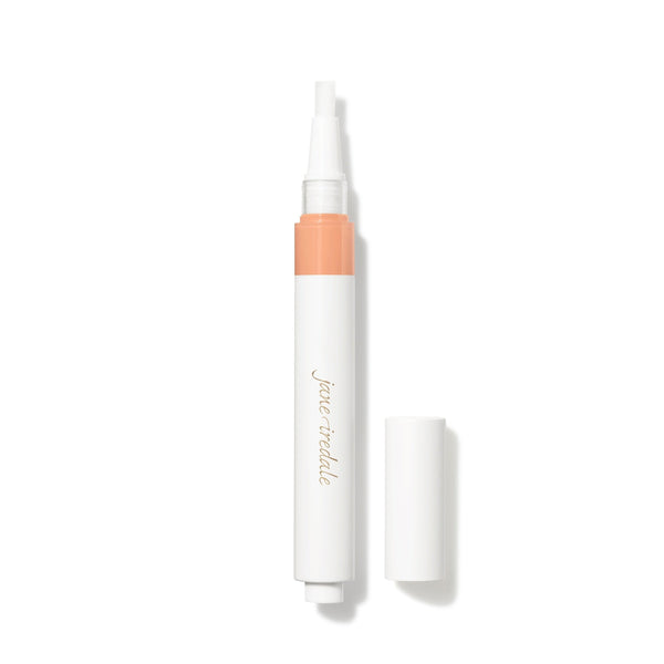 White cosmetic pen with peach-colored cap on a white background