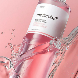 Medicube pink toner bottle with water droplets on a pink background