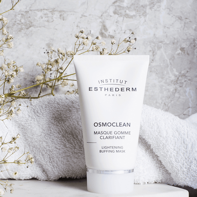 Institut Esthederm Osmoclean Lightening Buffing Mask in front of a towel