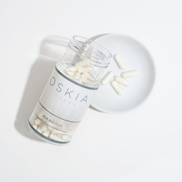 a bottle of OSKIA MSM Bio-Plus Supplements poured onto a plate