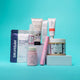 Collection of hair care products on a teal background