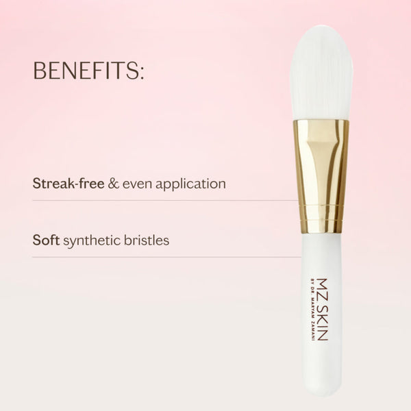 A white and gold makeup brush shown on a soft pink gradient background with text highlighting benefits: 'Streak-free & even application' and 'Soft synthetic bristles.' The brush has the brand name MZ SKIN printed vertically on the handle.