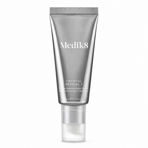 Medik8 Crystal Retinal 1 Power Retinal Night Serum in a metallic silver squeeze tube with a clear cap, shown on a plain white background.