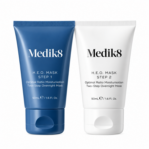 Two Medik8 H.E.O. Mask tubes side by side on a white background, one in blue for Step 1 and one in white for Step 2.