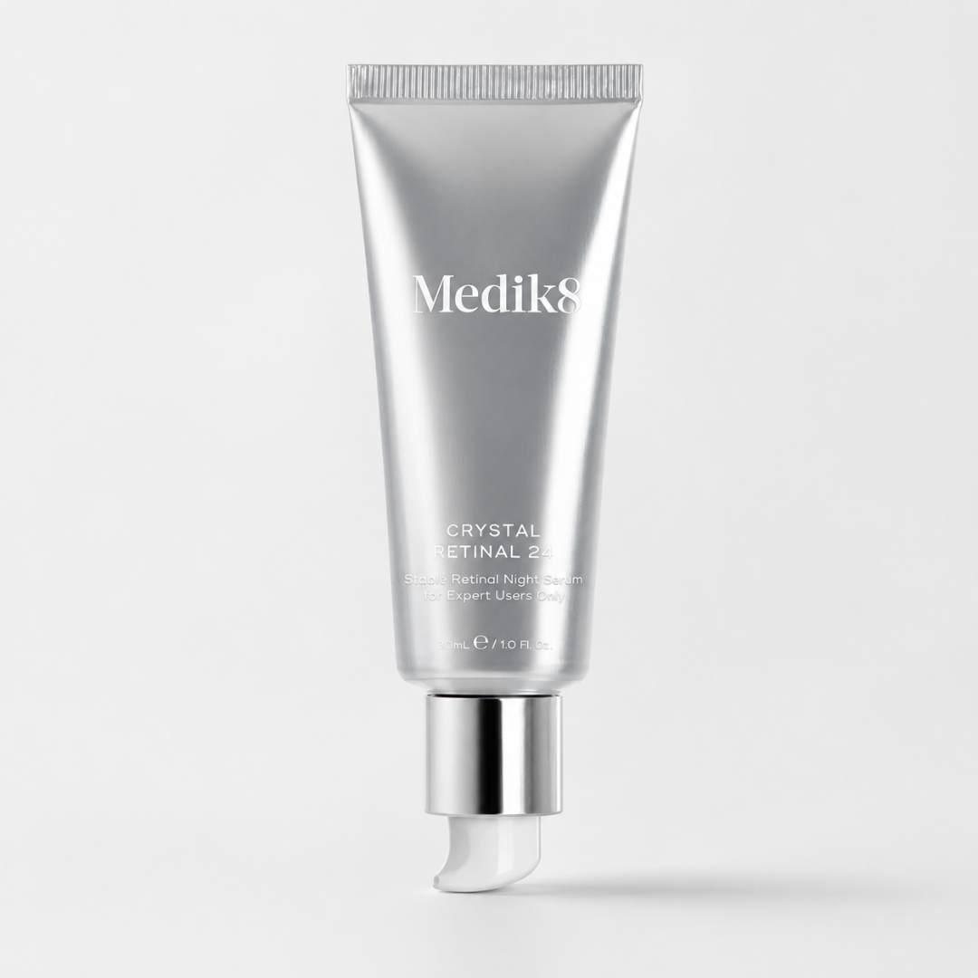 A silver squeeze tube of Medik8 Crystal Retinal 293 Retinol Night Cream with a metallic silver cap and a white pipette tip, centered on a light gray background.