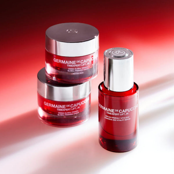 Three Germaine de Capuccini skincare products on a gradient red and white background