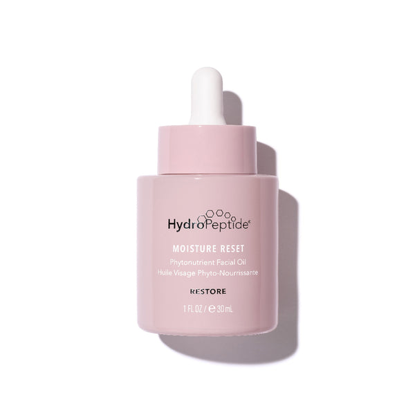 Pink skincare bottle with white cap on a light pink background