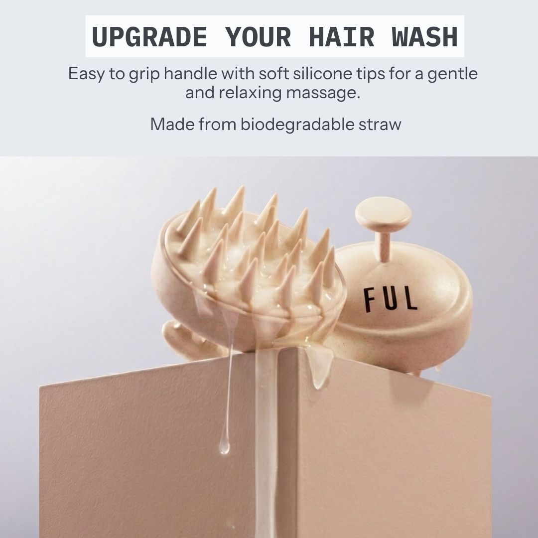 A beige hair massager brush with sharp silicone spikes and a matching round cap labeled 'FUL' sits on a beige pedestal. Text at the top reads 'UPGRADE YOUR HAIR WASH' with feature callouts about the easy-to-grip handle, soft silicone tips, and biodegradable straw material.