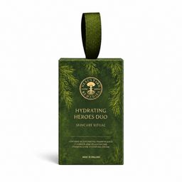 A green rectangular skincare ritual box with a matching hanging loop, featuring pine branch illustrations and the text 'Hydrating Heroes Duo' and 'Skincare Ritual'. The box is centered on a clean white background.