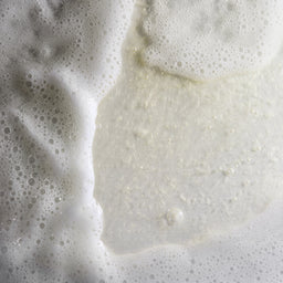 Close-up of a piece of bread with a cracked surface on a textured background
