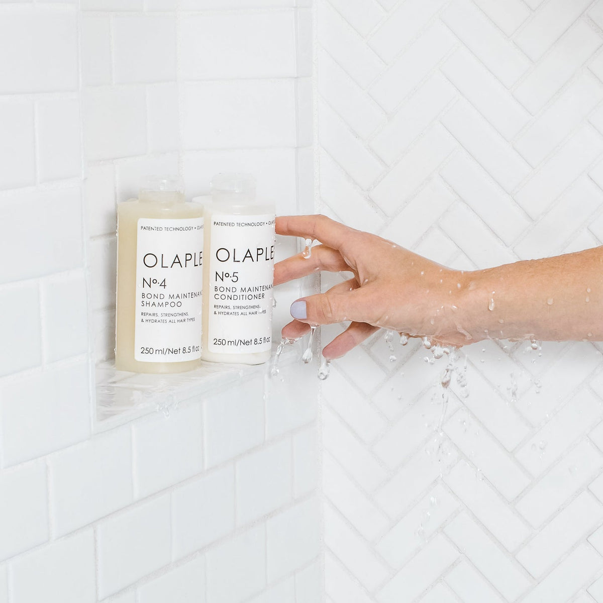 Olaplex No.4 Bond Maintenance Shampoo 250ml bottle in the shower