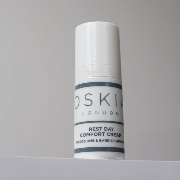 Skincare cream tube labeled 'Oskia London' on a gray background