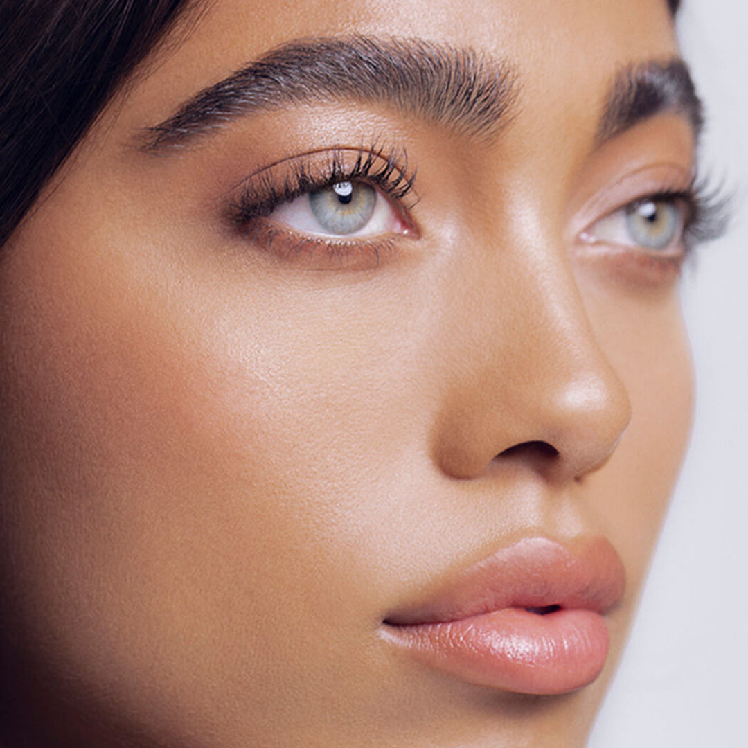 Close-up of a person's face with a neutral background