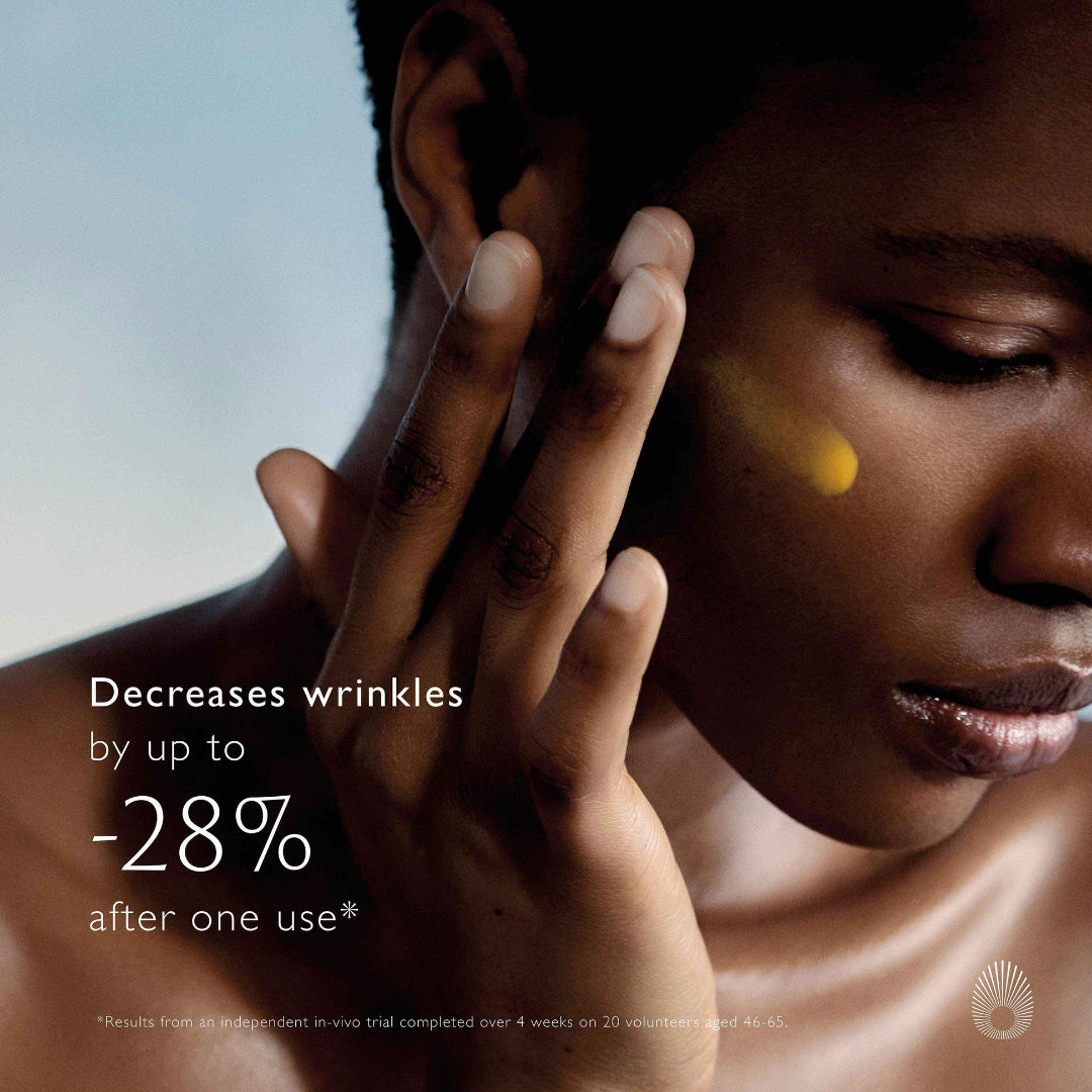 Close-up of a person's face with a hand touching their cheek, promoting a skincare product.