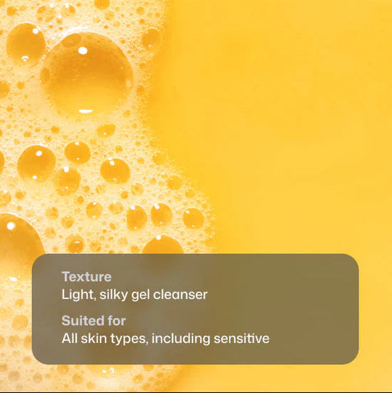 Yellow cleanser gel with rich foam bubbles on the left and a solid yellow background on the right, featuring a dark gray text box that reads: 'Texture Light, silky gel cleanser. Suited for All skin types, including sensitive'.