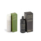 Irene Forte skincare set featuring a white spray bottle, an olive green box, and a black dropper bottle with its dark gray box, displayed on a clean white background.
