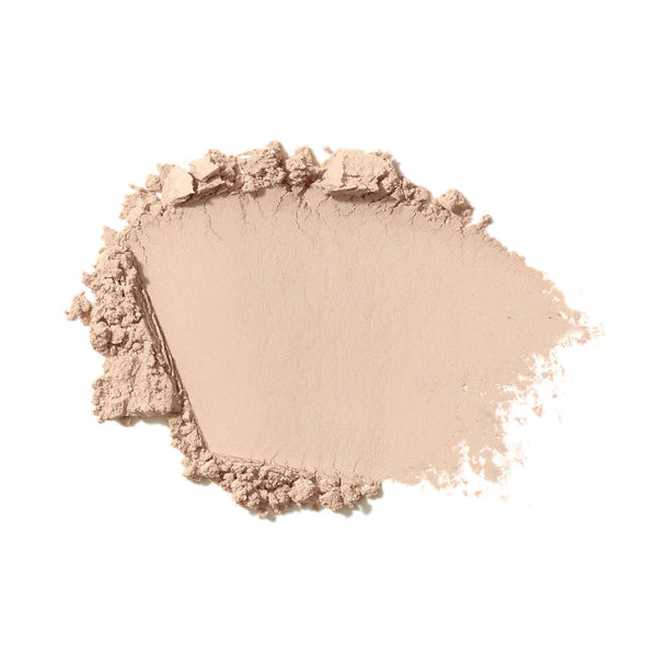 Beige makeup powder on a white background
