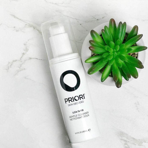 PRIORI LCA - Gentle Cleanser bottle next to a plant