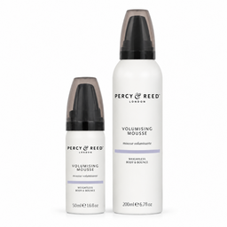 Two white bottles of Percy Reed London Volumising Mousse, one 50ml and one 200ml, with black caps and a subtle lavender accent stripe on the labels, set against a plain white background.
