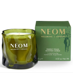 An olive green glass scented candle with a wick and white wax, shown next to its matching green packaging box. The brand NEOM is clearly visible on both the candle and the box.