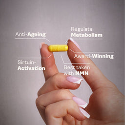 Hand holding a yellow pill with text on key benefits against a gray background