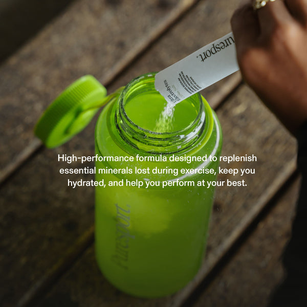 Sports drink bottle with a runner pouring electrolytes by Puresport in it. 