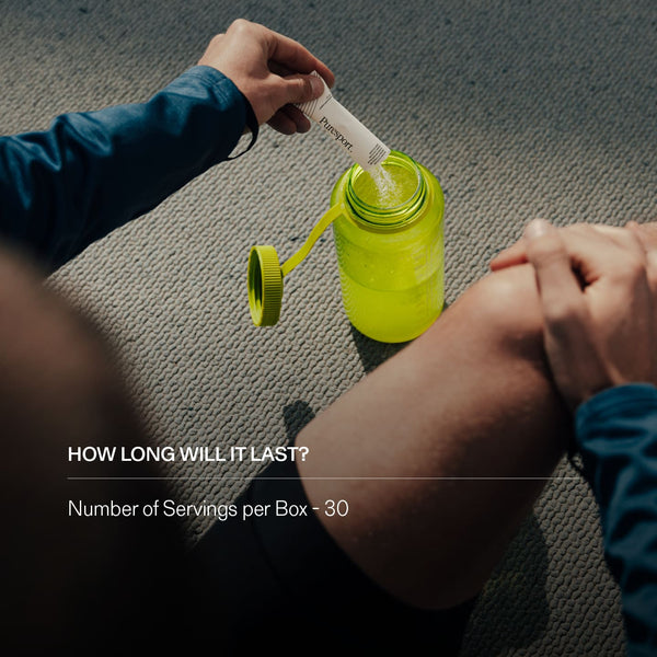 Person opening a yellow sports bottle pouring a citrus salt electrolyte sachet into it. 