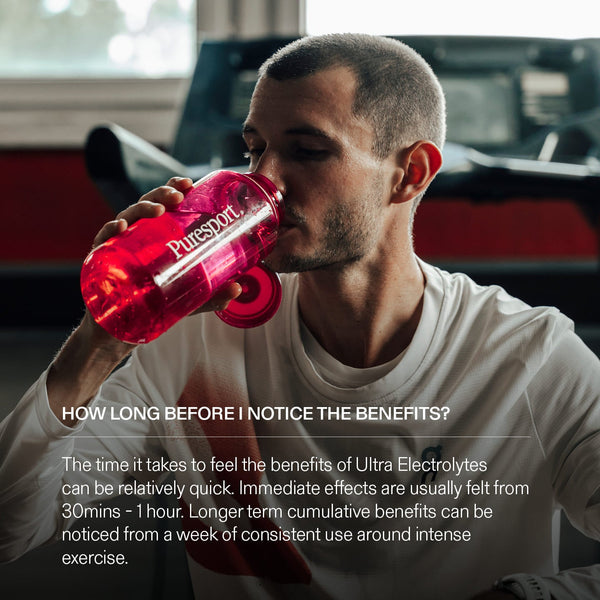 Runner drinking from a red 'Puresport' sports bottle after a treadmill session