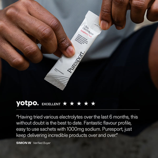Puresport electrolyte sachet held by a track runner with a yotpo review displayed below.