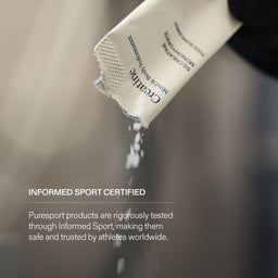 Creatine being poured from a Puresport Sachet with Informed Sports Certified text on it. 