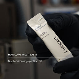 Hand holding a supplement of creatine by Puresport with the number of servings per box. 