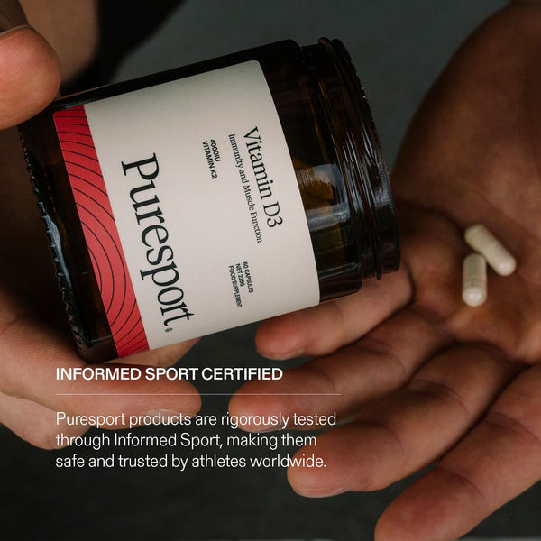 Puresport Vitamin D3 supplement jar held by a runner with Informed Sport Certified text overlayed. 