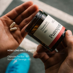 Person holding a supplement jar of Vitamin D3 capsules by Puresport with text about duration and contents.