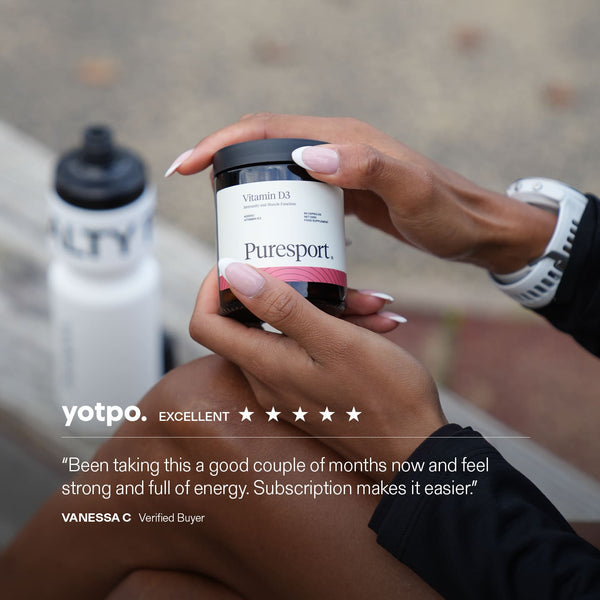 Runner holding a Puresport supplement jar of Vitamin D3 with a Puresport bottle in the background.