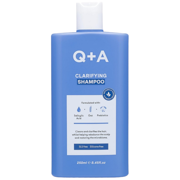 Blue shampoo bottle with 'Q+A' branding on a white background
