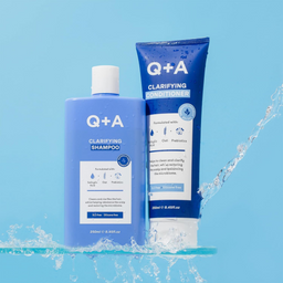 Q+A clarifying shampoo and conditioner on a blue background with water splashes