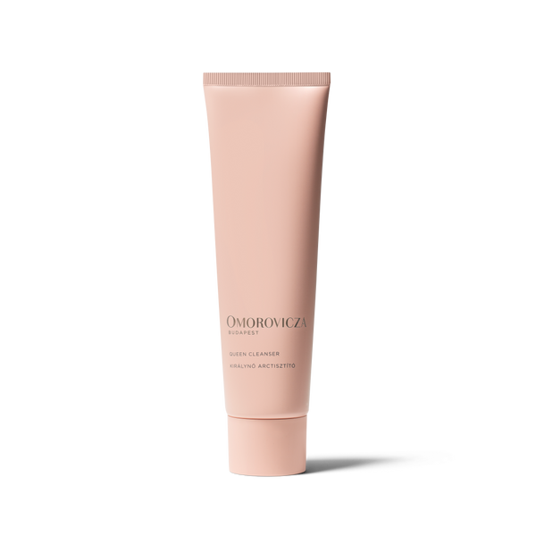 A single tube of Omorovicza Dispefy Skin Cleanser in a pale pink color, standing upright on a white background with a soft shadow.
