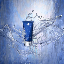 Blue skincare tube with water splashes on a blue background